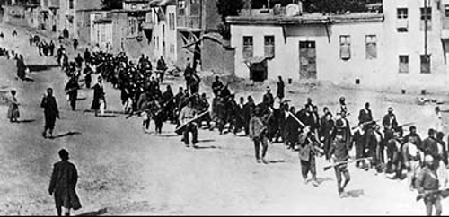 Armenians are marched to a nearby prison in Mezireh by armed Turkish soldiers, 1915.