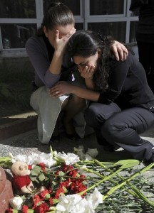 Relatives of the victims react after laying floral wreaths at the university where at least 10 people died in the shooting incident. The dead included at least two women. (Reuters)