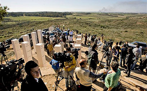 Reporters, banned from entering Gaza, watch Israel's "Operation Cast Lead" from a distant hilltop (AP)