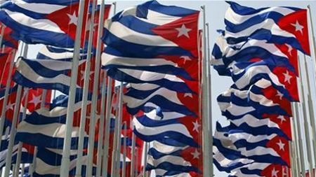 Cuban flags fly beside the Interests Section Office of the United States in Havana a day before the 56th anniversary of the start of the Cuban revolution, July 25, 2009 (Desmond Boylan / Reuters)