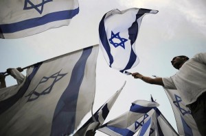 Israeli youths wave flags.