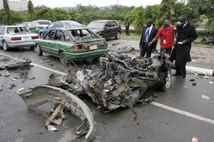 Investigators inspect an exploded vehicle in Abuja. (Pius Utomi Ekpei/AFP/Getty Images)