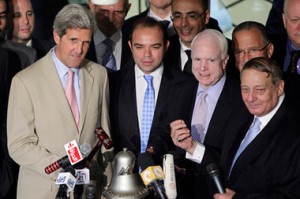 Senators John Kerry (left) and John McCain (third from left) ring the bell to pen the Cairo stock exchange market on June 26, 2011 (Amr Nabil/AP)