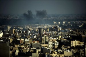 Smoke rises over Tripoli, Libya, on August 22, 2011 (Filippo Monteforte/AFP)