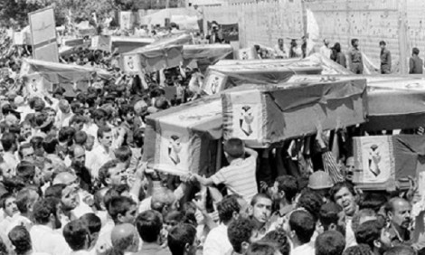 Mourners carry coffins through the streets of Tehran, July 7, 1988, during a mass funeral for victims who died when Iran Air Flight 655 was blown out of the sky by the USS Vincennes. (Associated Press)