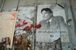 A poster of Palestinian scholar and activist Edward W. Said pasted onto the annexation wall Israel has illegally constructed in the West Bank (Justin McIntosh/Wikimedia Commons)