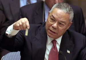 At the UN, Colin Powell holds a model vial of anthrax, while arguing that Iraq is likely to possess WMDs. 5 February 2003. (Wikimedia Commons)