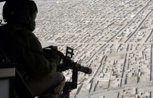 AFGHANISTAN/ A member of the NATO-led coalition force on a helicopter patrol in Kandahar, southern Afghanistan. Afghans have long demanded an end to misuse of aerial fire power and night time raids. Photo - Reuters