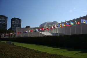 Row of flags in front of the UN General Assembly building, Manhattan, New York. (Yerpo/Wikimedia Commons)