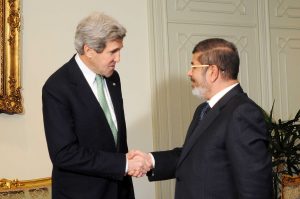 Secretary of State John Kerry shakes hands with Egyptian President Mohammed Morsi on March 3, 2013. The US subsequently supported a military coup that overthrew Morsi. (US Department of State)