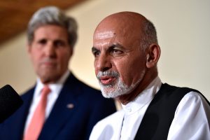 Ashraf Ghani, then a presidential candidate, addresses reporters as US Secretary of State John Kerry U.S. Secretary of State John Kerry looks on, July 12, 2014 (US State Department)