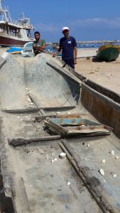 Mohammed and his fellow with his destroyed ship.