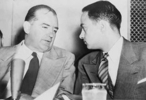 Sen. Joseph McCarthy chats with his attorney Roy Cohn during Senate Subcommittee hearings on the McCarthy-Army dispute, 1954 (Library of Congress)