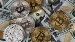 US hundred dollar bills and bitcoin coins (Public Domain)